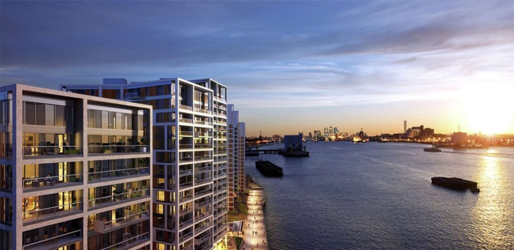 Modern waterfront apartment buildings at sunset overlooking city harbour