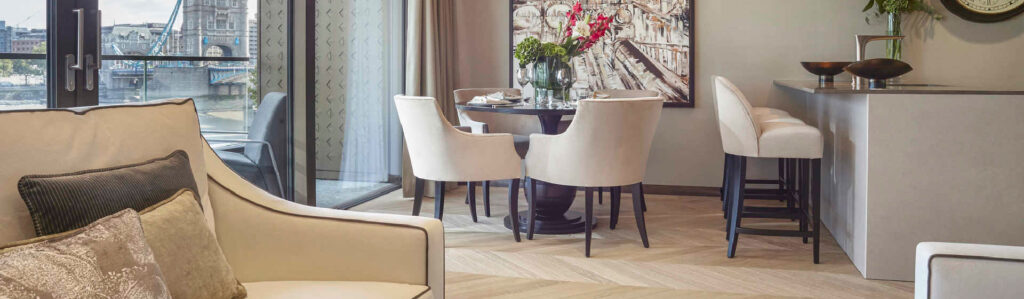 Luxury apartment dining area overlooking river with modern furnishings