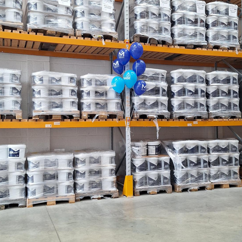 Warehouse shelving with wrapped products and promotional balloons